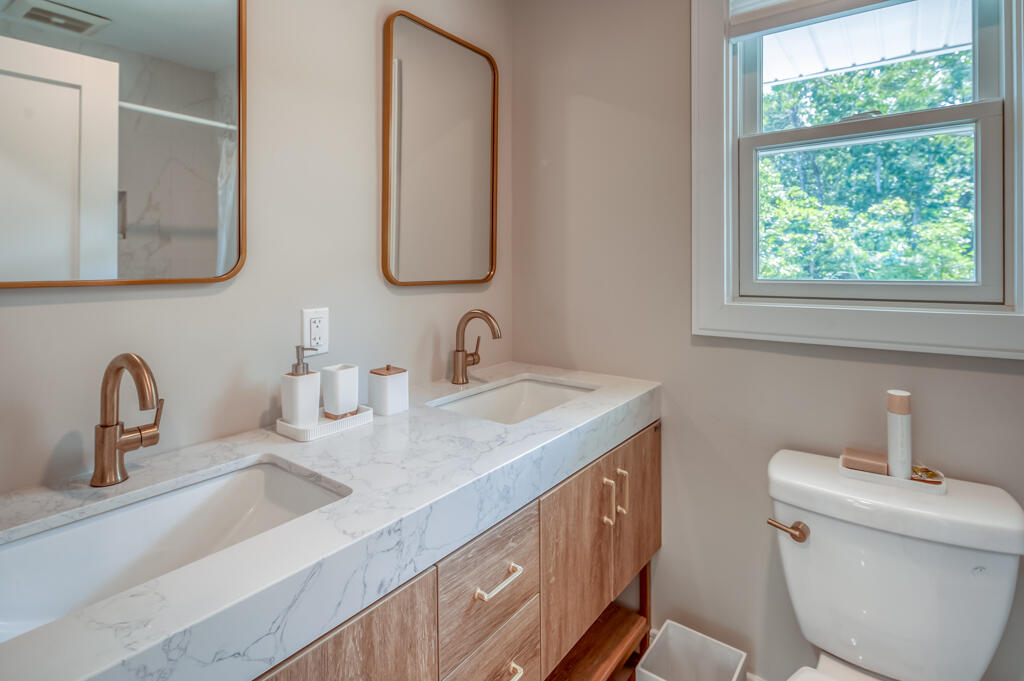 99 The Boulevard Edgartown, MA 02539 - Photo 29 of 35 a bathroom with a double vanity sink and a mirror