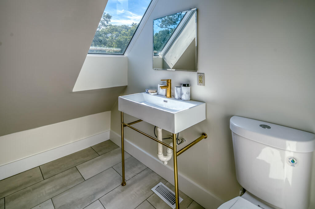 99 The Boulevard Edgartown, MA 02539 - Photo 30 of 35 a bathroom with a sink toilet and a mirror