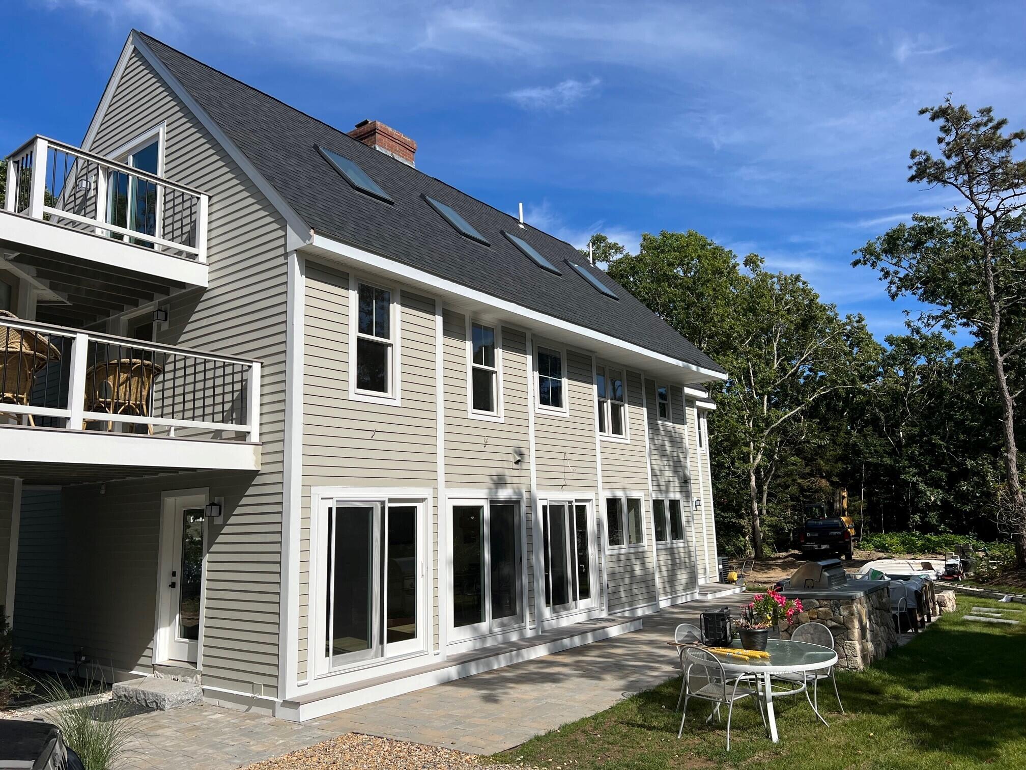 99 The Boulevard Edgartown, MA 02539 - Photo 33 of 35 a backyard of a house with table and chairs