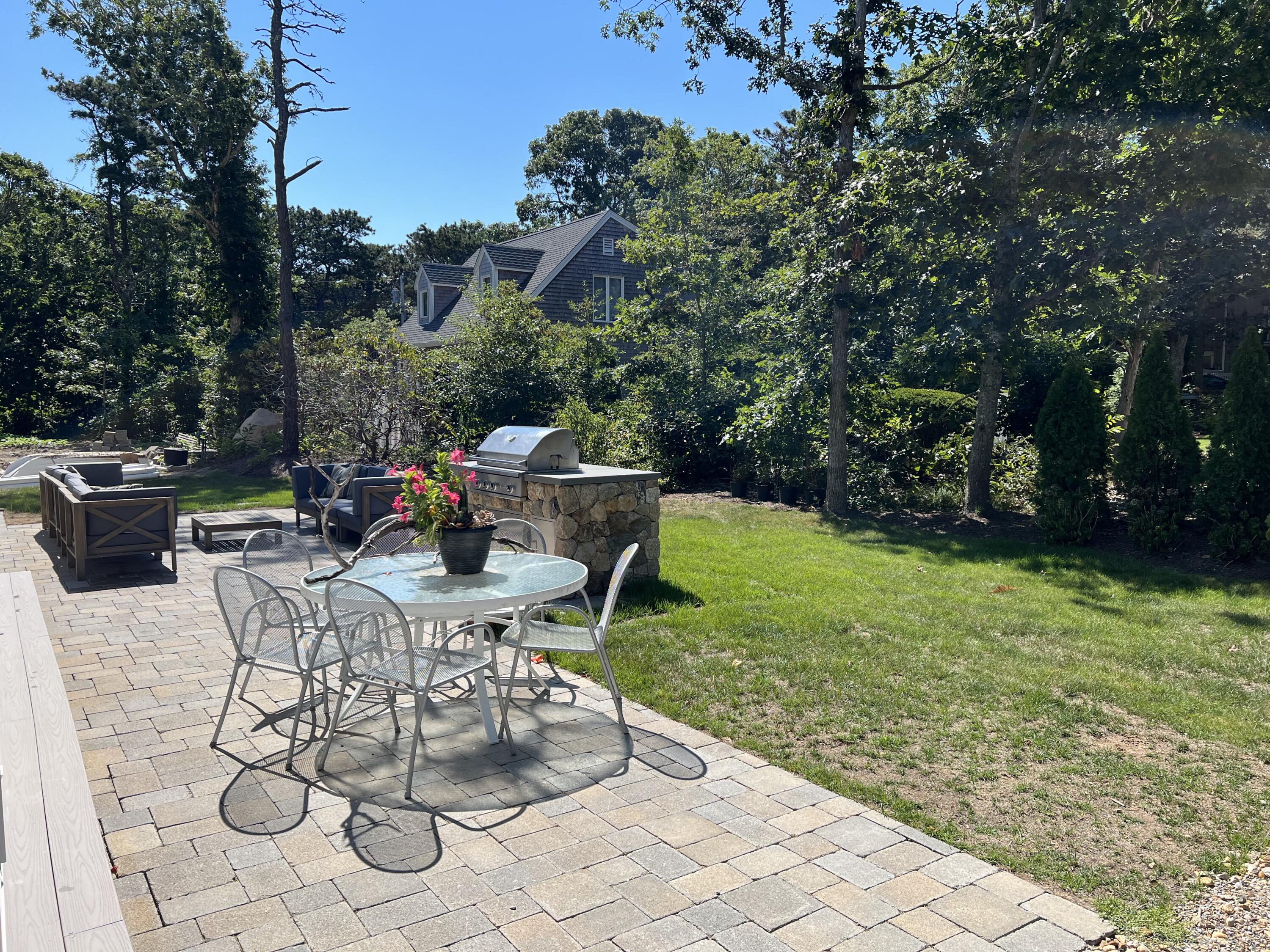 99 The Boulevard Edgartown, MA 02539 - Photo 6 of 35 a view of backyard with seating space and trees