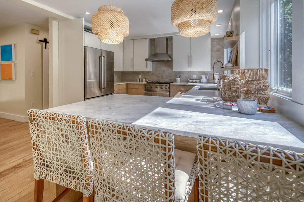 99 The Boulevard Edgartown, MA 02539 - Photo 9 of 35 a large kitchen with stainless steel appliances kitchen island granite countertop a refrigerator and a stove