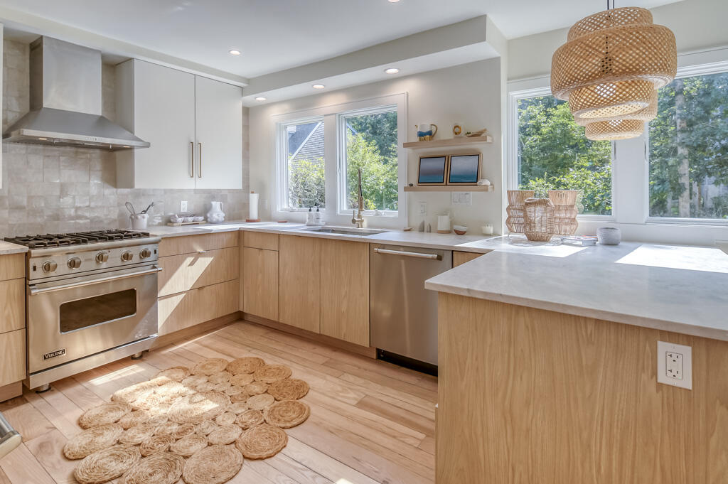99 The Boulevard Edgartown, MA 02539 - Photo 10 of 35 a kitchen with stainless steel appliances granite countertop a stove a sink and a microwave