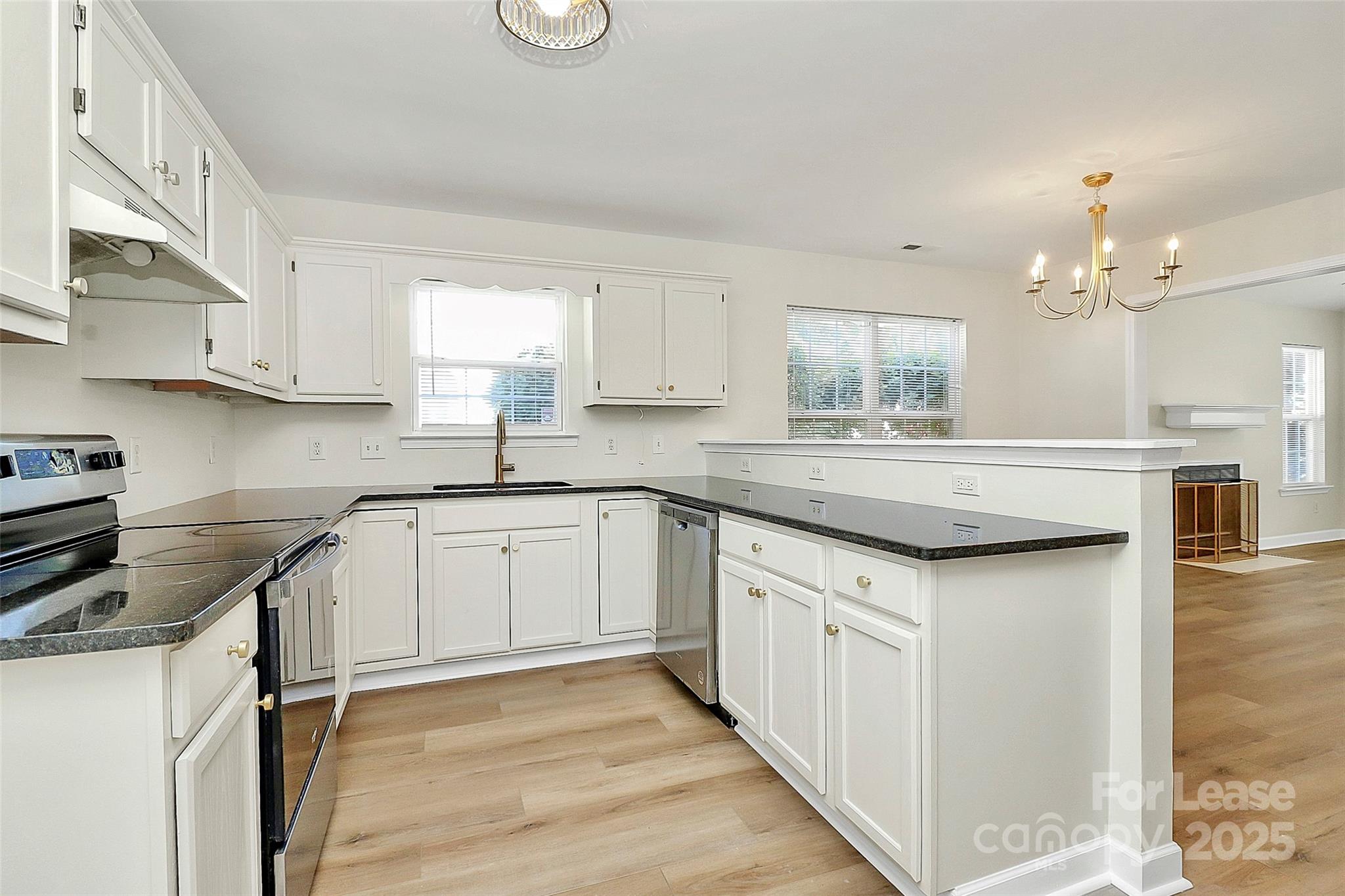 6320 Fresh Wind Avenue Charlotte, NC 28212 - Photo 11 of 31 a kitchen with granite countertop white cabinets and white appliances