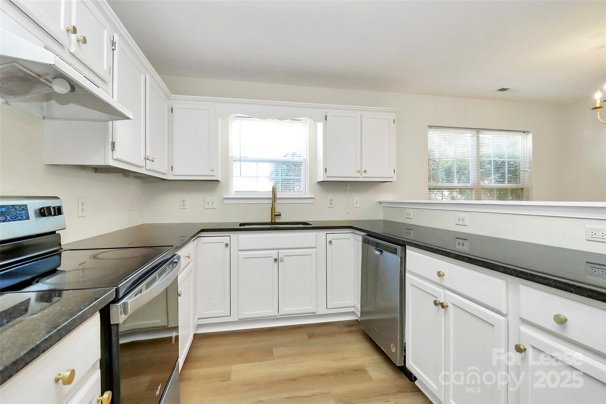 6320 Fresh Wind Avenue Charlotte, NC 28212 - Photo 12 of 31 a kitchen with granite countertop white cabinets and white appliances