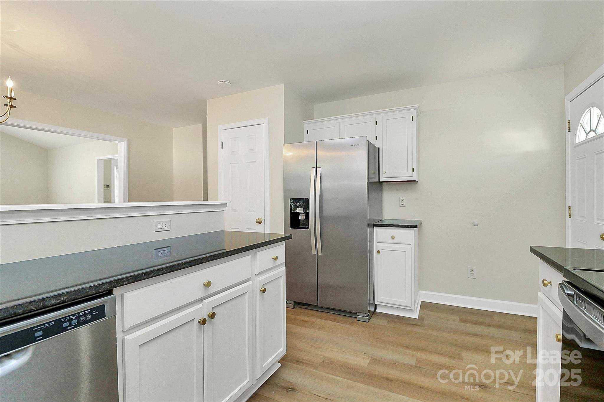 6320 Fresh Wind Avenue Charlotte, NC 28212 - Photo 13 of 31 a kitchen with stainless steel appliances a refrigerator and a stove top oven