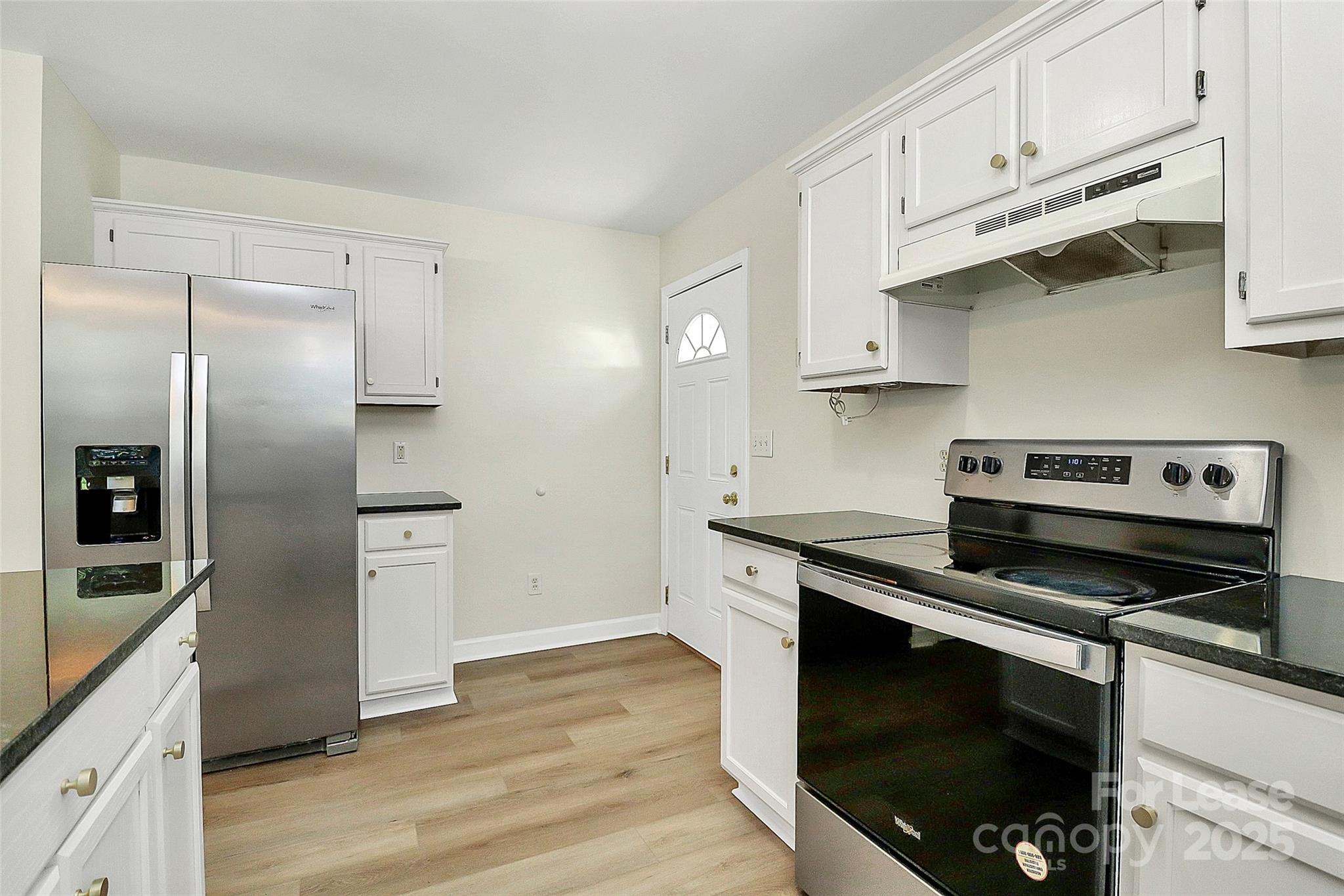 6320 Fresh Wind Avenue Charlotte, NC 28212 - Photo 15 of 31 a kitchen with stainless steel appliances and wooden cabinets