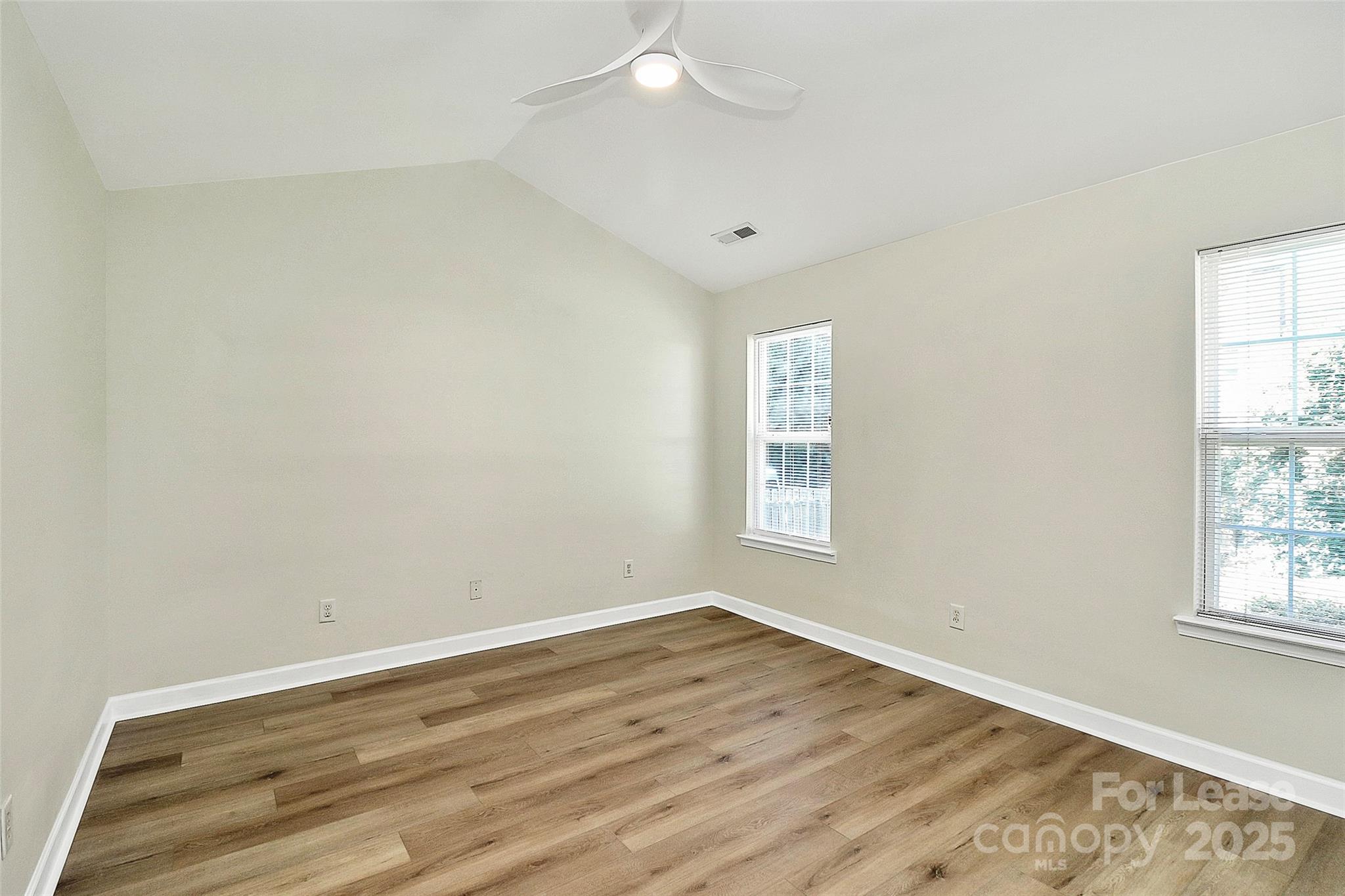 6320 Fresh Wind Avenue Charlotte, NC 28212 - Photo 17 of 31 an empty room with wooden floor and windows