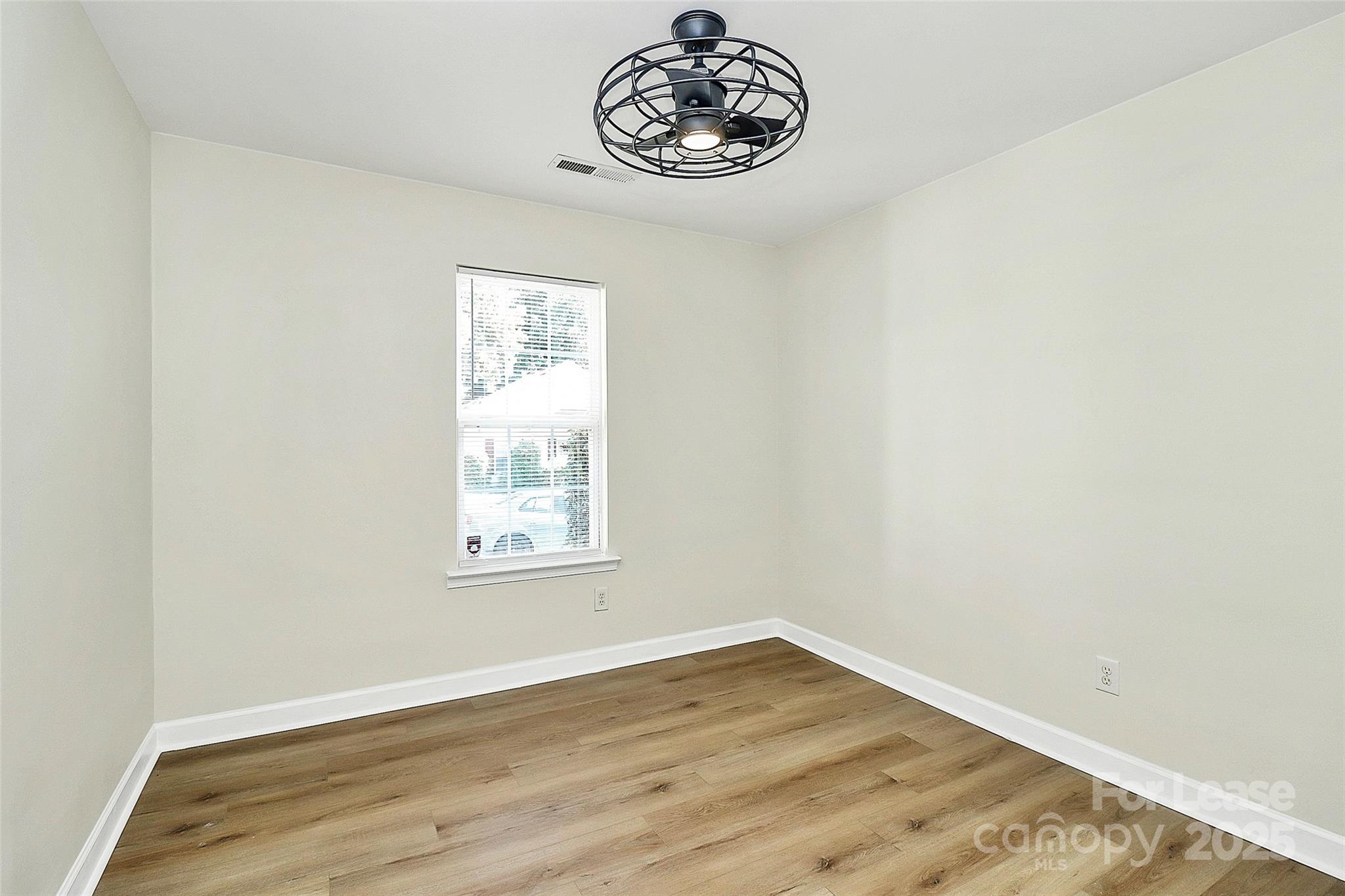 6320 Fresh Wind Avenue Charlotte, NC 28212 - Photo 22 of 31 an empty room with wooden floor and window