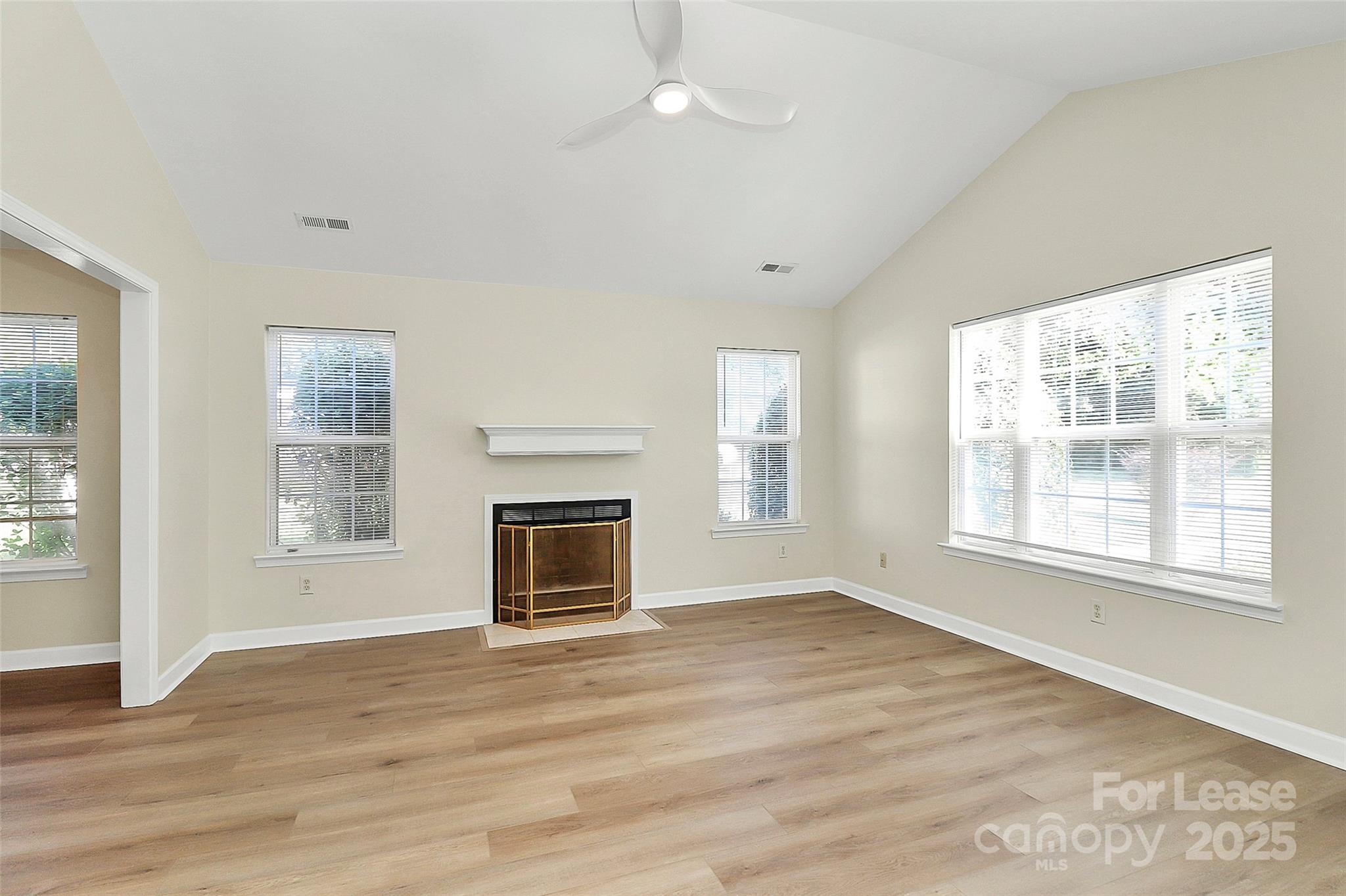 6320 Fresh Wind Avenue Charlotte, NC 28212 - Photo 6 of 31 a view of an empty room with wooden floor and a window