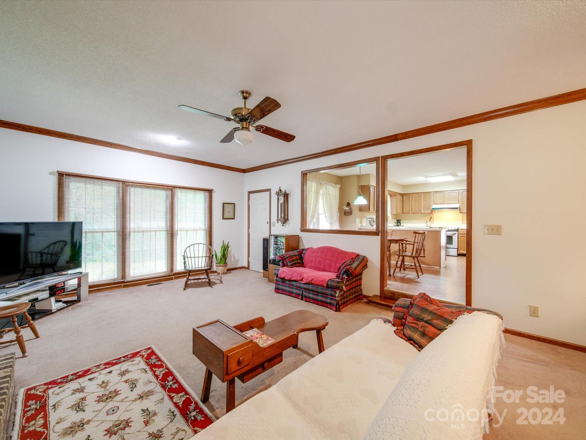 1557 Woodcroft Drive Fort Mill, SC 29708 - Photo 14 of 46 a living room with furniture a flat screen tv and a large window