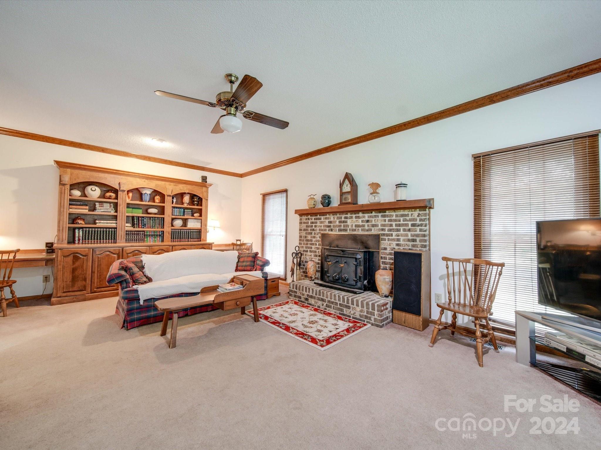 1557 Woodcroft Drive Fort Mill, SC 29708 - Photo 15 of 46 a living room with furniture a fireplace and a flat screen tv