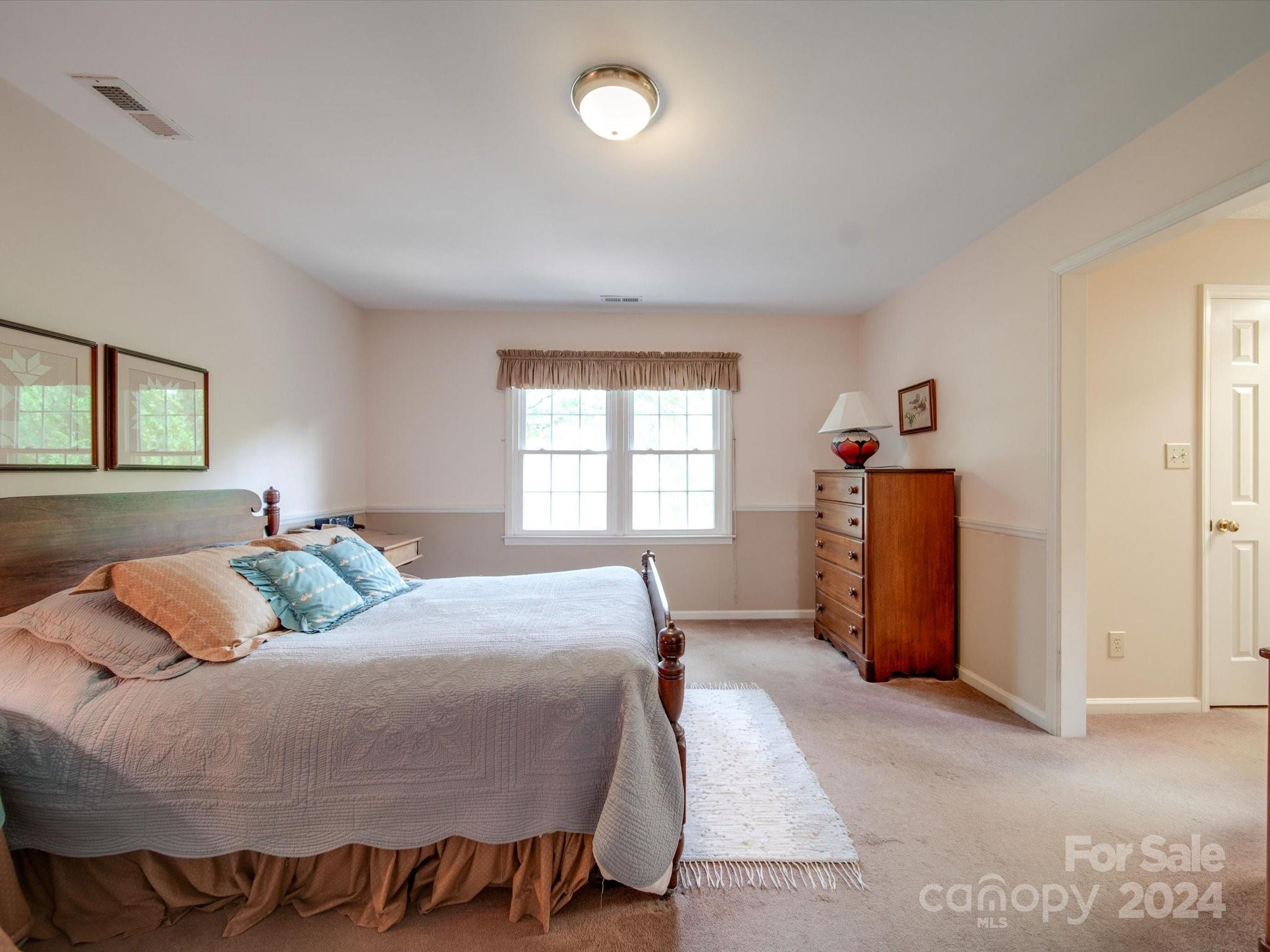 1557 Woodcroft Drive Fort Mill, SC 29708 - Photo 21 of 46 a bedroom with a bed and a window