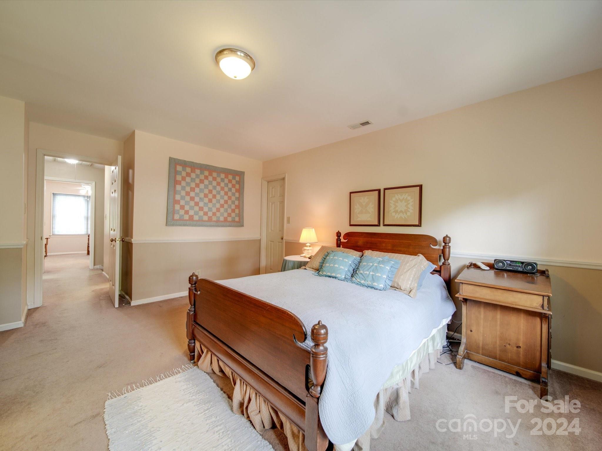 1557 Woodcroft Drive Fort Mill, SC 29708 - Photo 23 of 46 a bedroom with a bed and a lamp with window