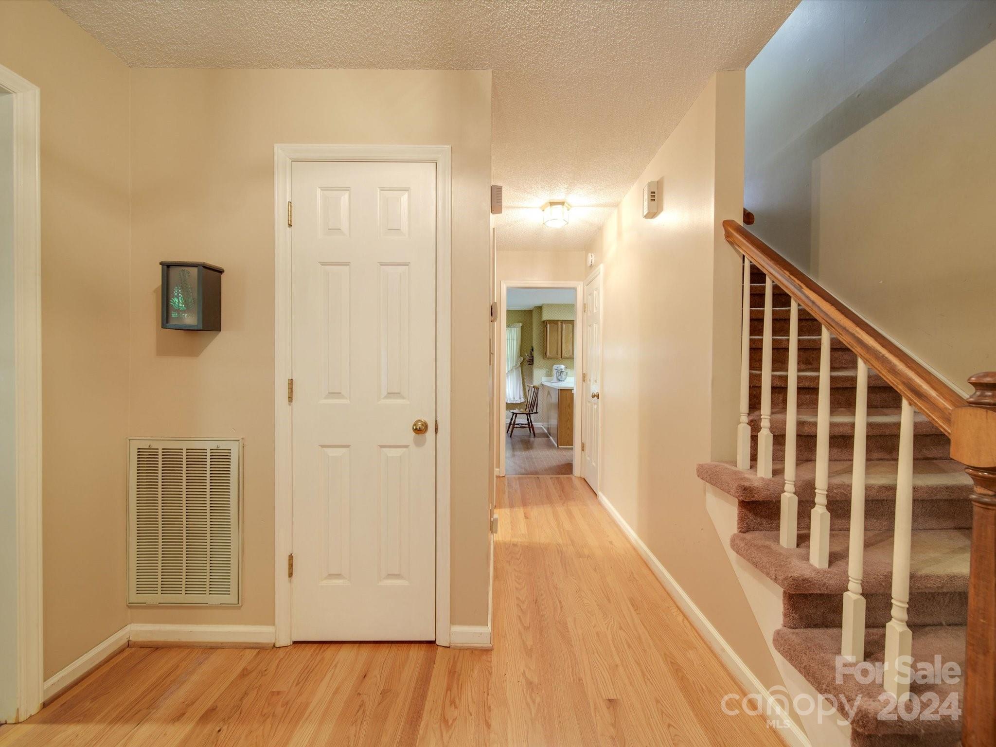 1557 Woodcroft Drive Fort Mill, SC 29708 - Photo 3 of 46 a view of a hallway with wooden floor and staircase