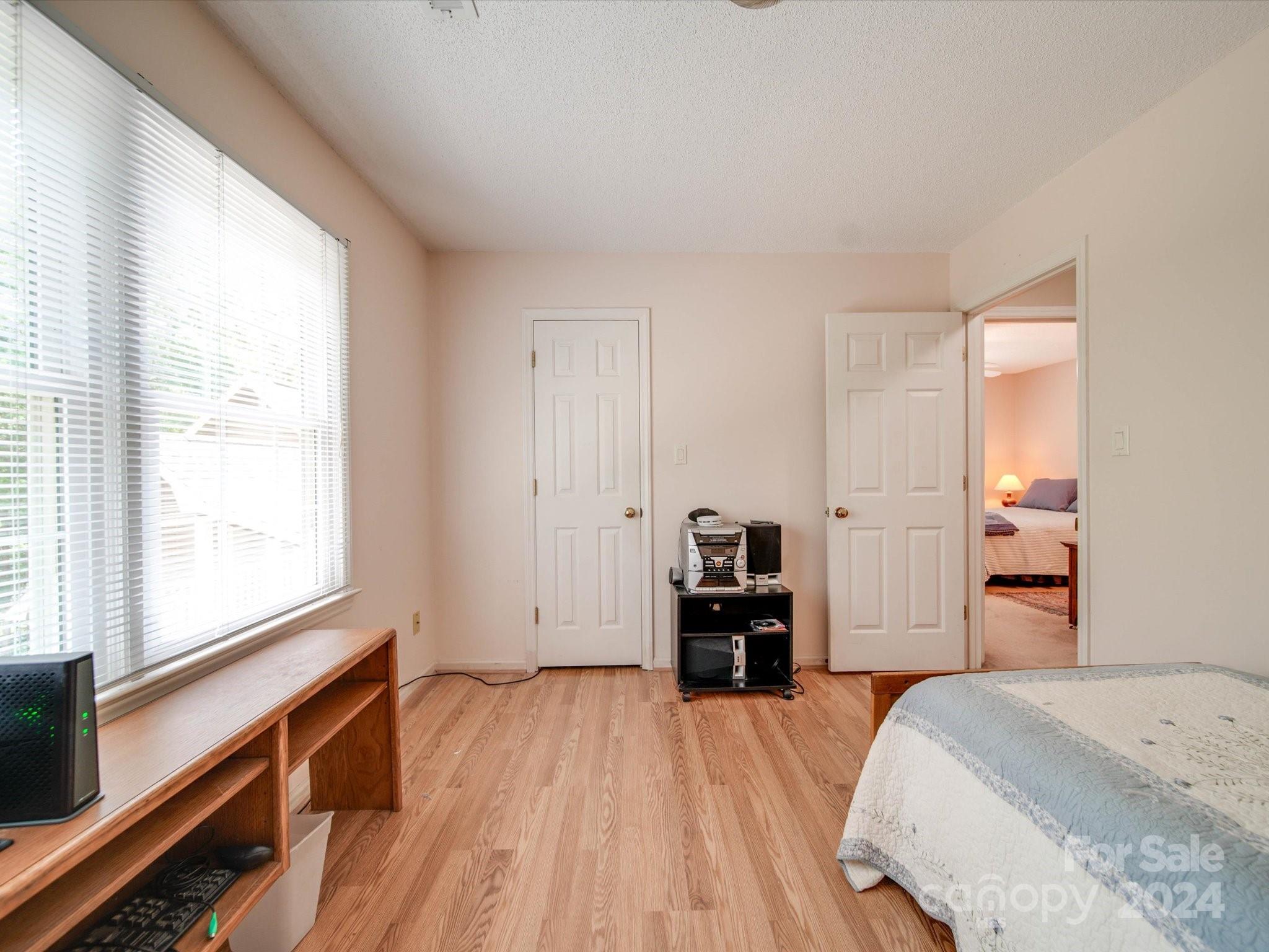 1557 Woodcroft Drive Fort Mill, SC 29708 - Photo 32 of 46 a bedroom with a bed and a dresser next to a window