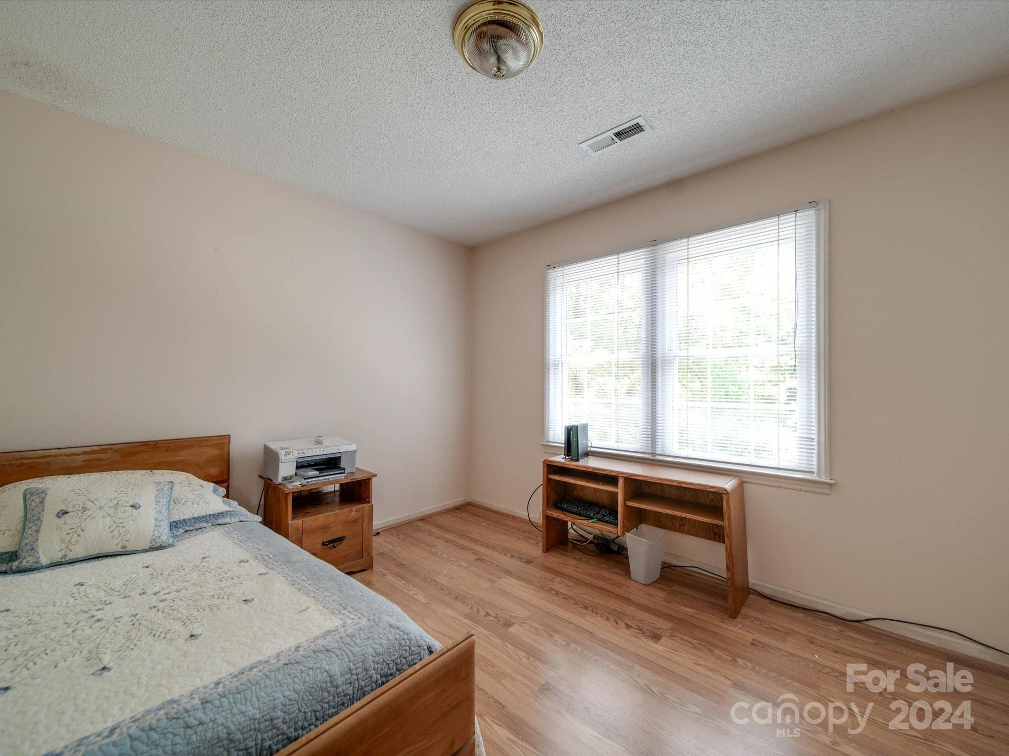 1557 Woodcroft Drive Fort Mill, SC 29708 - Photo 33 of 46 a bedroom with a bed and a window