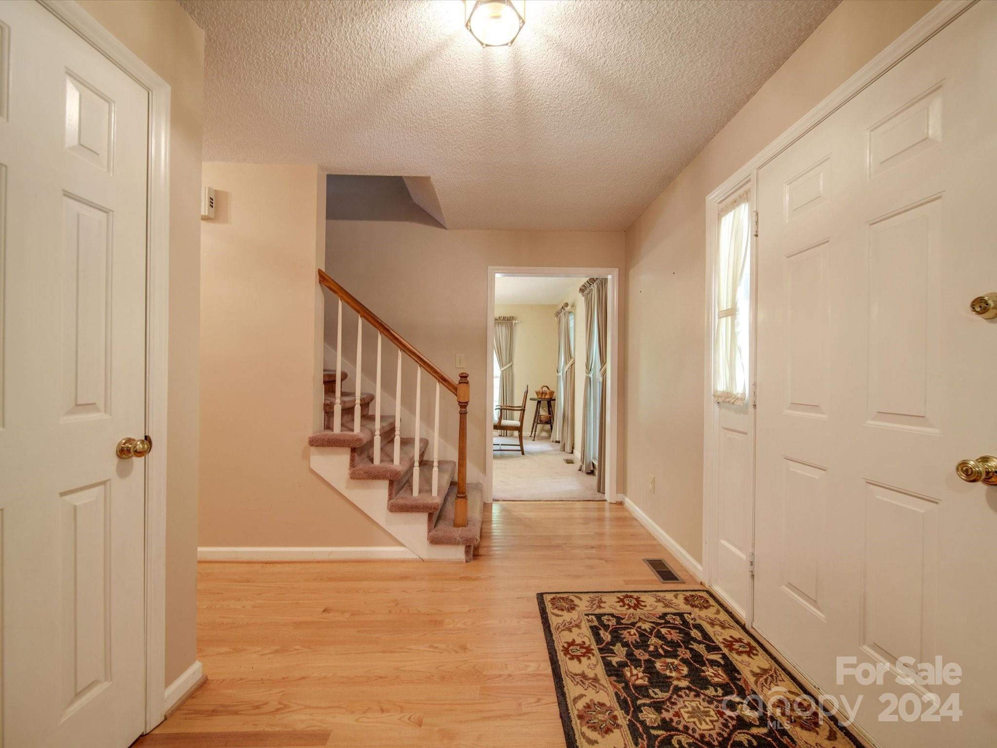 1557 Woodcroft Drive Fort Mill, SC 29708 - Photo 4 of 46 a view of a hallway with wooden floor and staircase