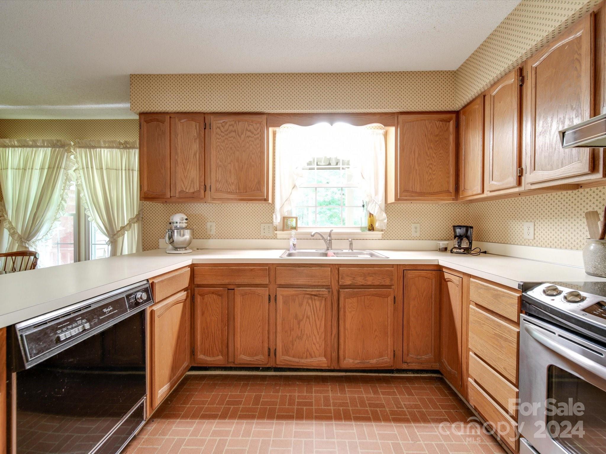 1557 Woodcroft Drive Fort Mill, SC 29708 - Photo 5 of 46 a kitchen with a sink stove top oven and cabinets