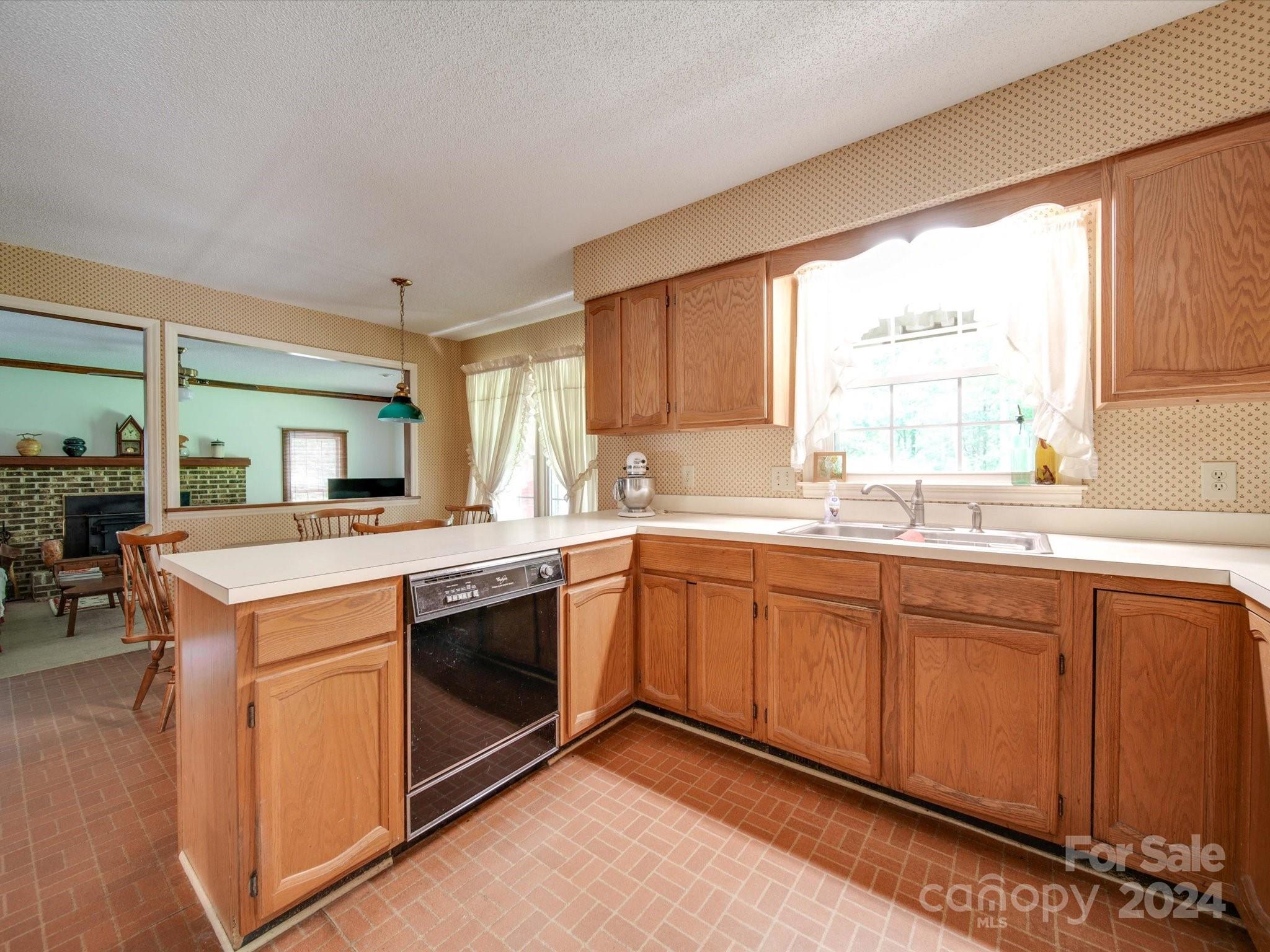1557 Woodcroft Drive Fort Mill, SC 29708 - Photo 7 of 46 a kitchen with granite countertop a sink stainless steel appliances and cabinets