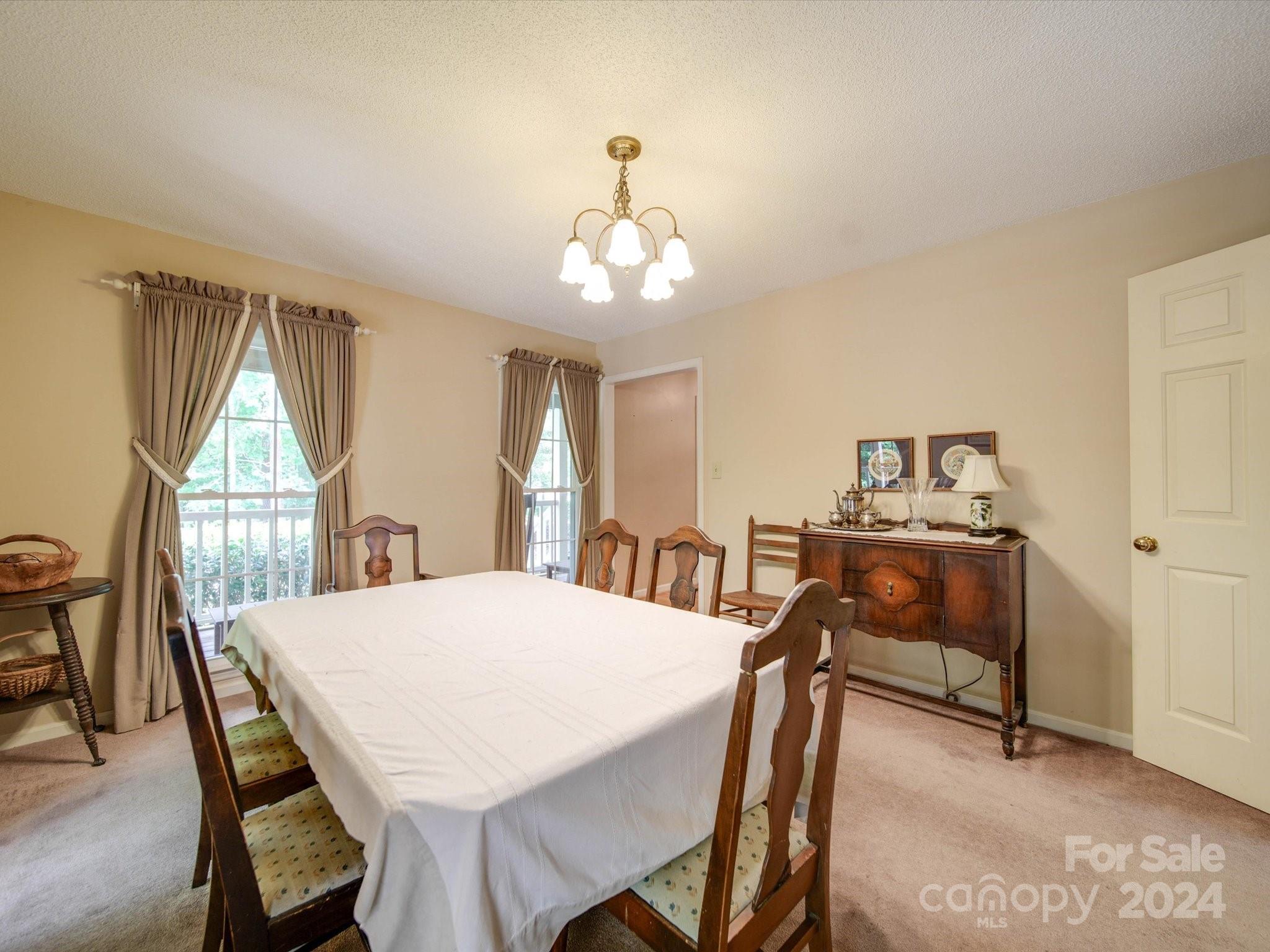 1557 Woodcroft Drive Fort Mill, SC 29708 - Photo 8 of 46 a view of a dining room with furniture and a window