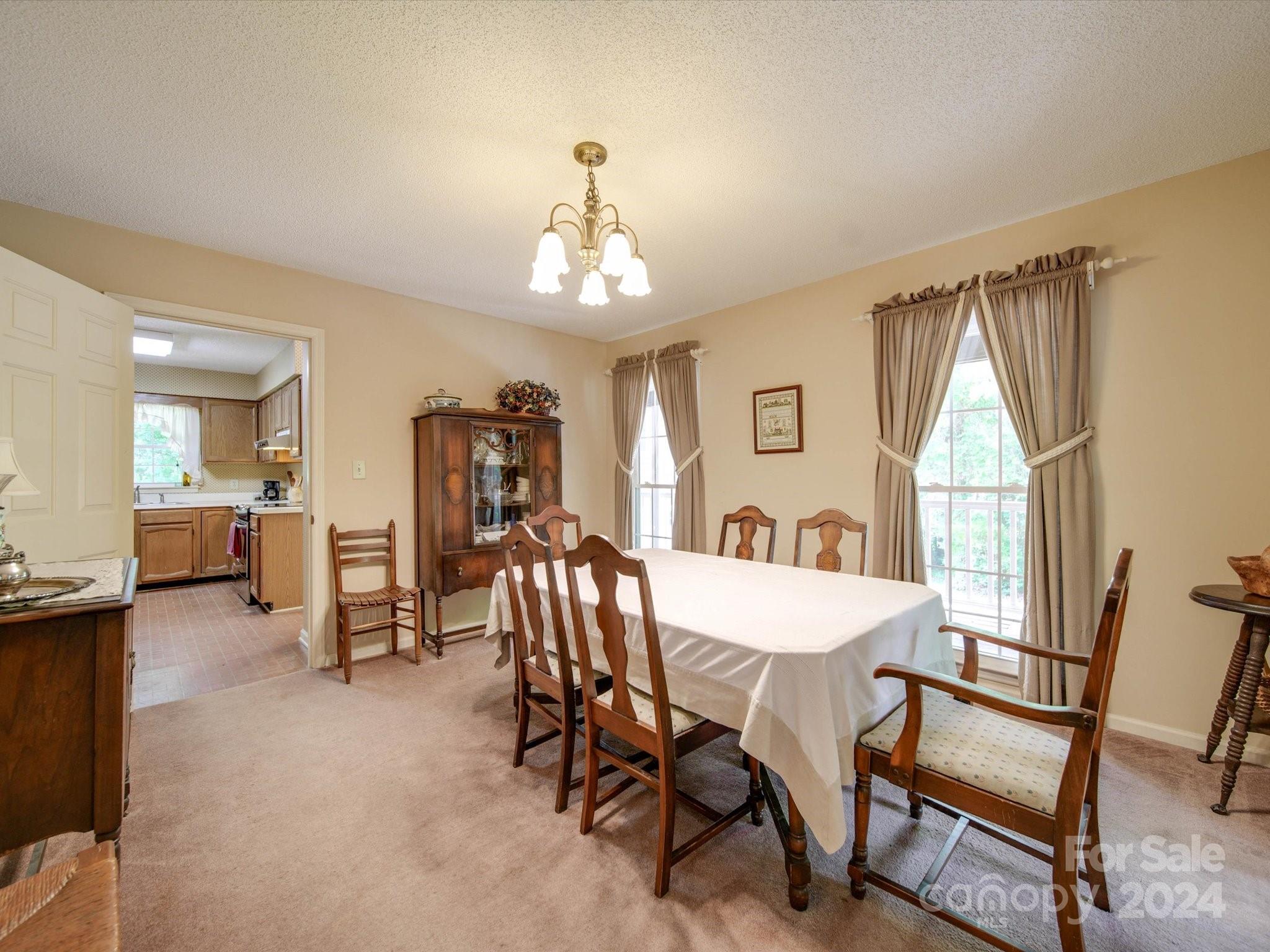 1557 Woodcroft Drive Fort Mill, SC 29708 - Photo 9 of 46 a view of a dining room with furniture and a chandelier
