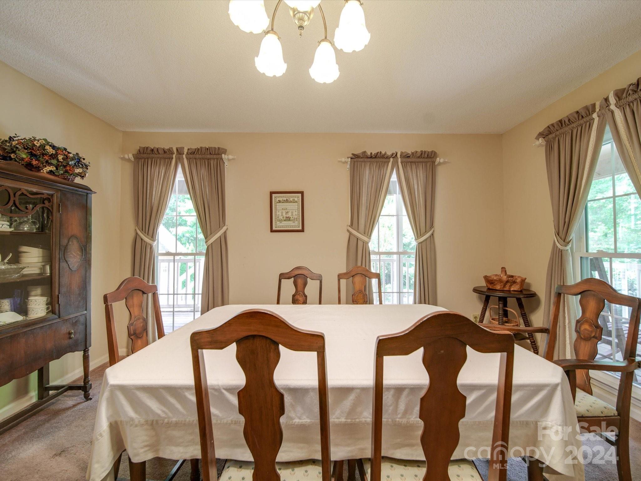 1557 Woodcroft Drive Fort Mill, SC 29708 - Photo 10 of 46 a view of a dining room with furniture and windows
