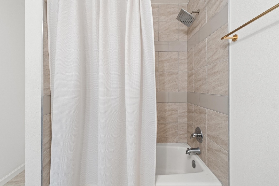 3604 Clawson Road, Unit 203 Austin, TX 78704 - Photo 17 of 37 a bath room with a shower curtain and a sink