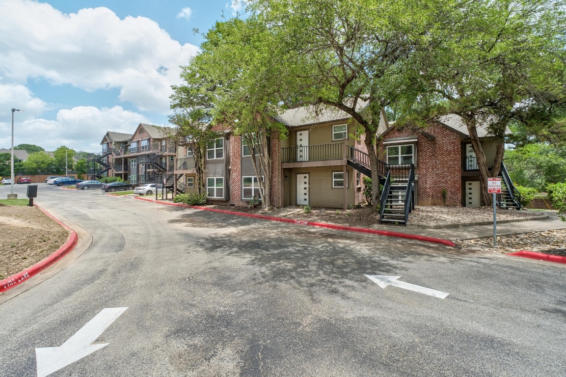 3604 Clawson Road, Unit 203 Austin, TX 78704 - Photo 26 of 37 a front view of a house with a yard and garage
