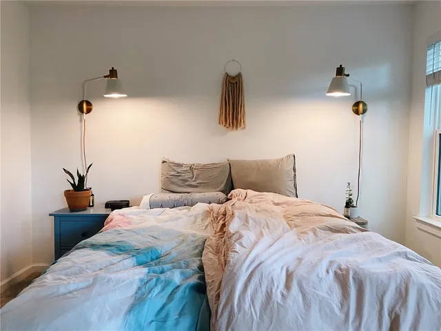 a bedroom with bed and window