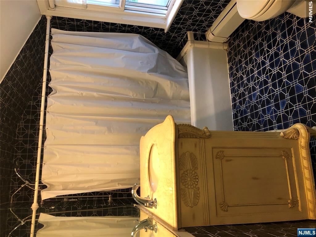 474 Grove Street Ridgewood, NJ 07450 - Photo 17 of 19 a bathroom with a sink and a shower