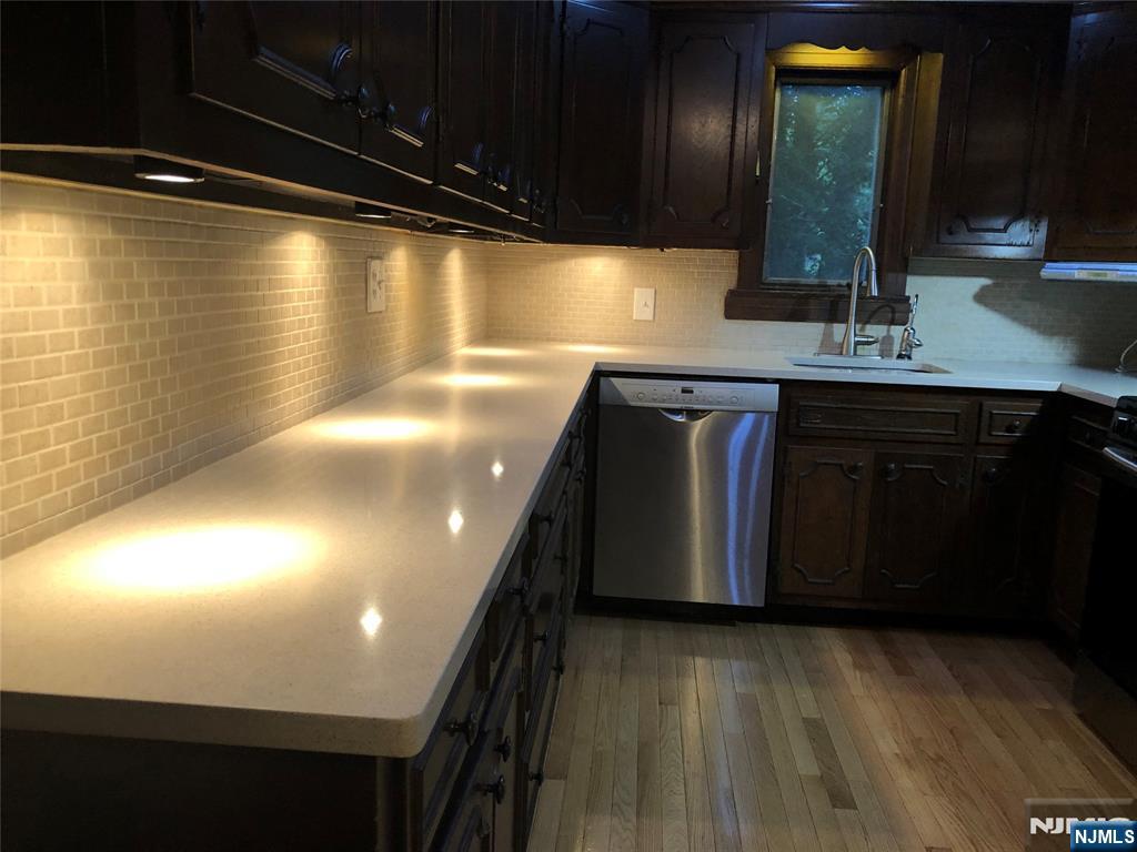 474 Grove Street Ridgewood, NJ 07450 - Photo 2 of 19 a kitchen with stainless steel appliances a sink and cabinets