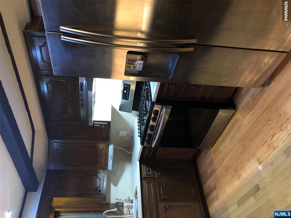 474 Grove Street Ridgewood, NJ 07450 - Photo 3 of 19 a kitchen with stainless steel appliances granite countertop a refrigerator and a sink
