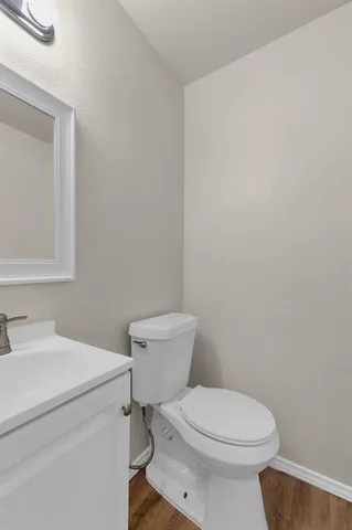 a white toilet sitting next to a bathroom sink