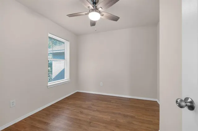 wooden floor in an empty room with a window