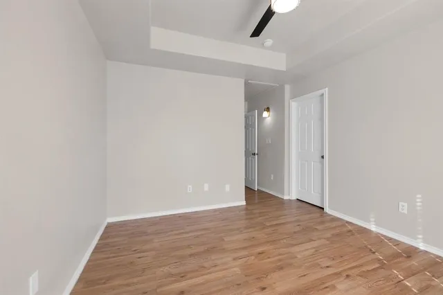 a view of an empty room with wooden floor
