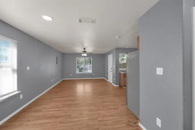 wooden floor in an empty room with a window