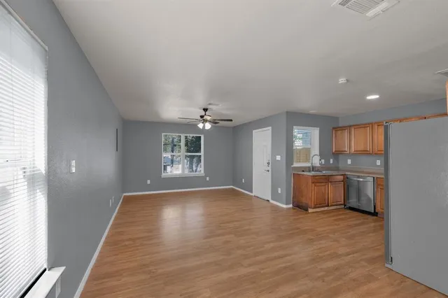 a view of a kitchen with a sink and a window