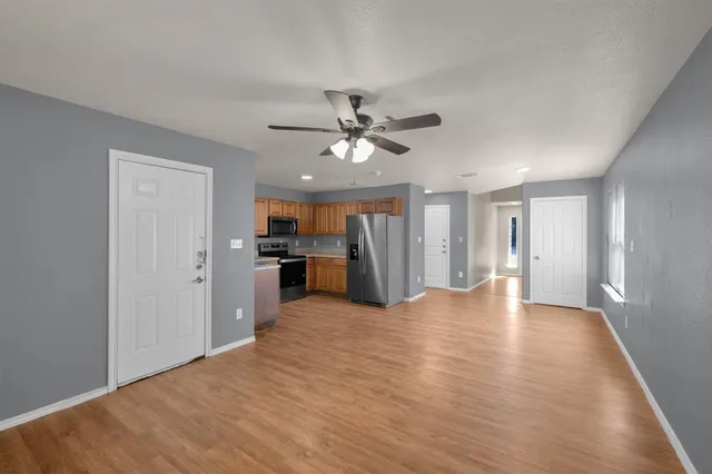 a view of an empty room with a kitchen