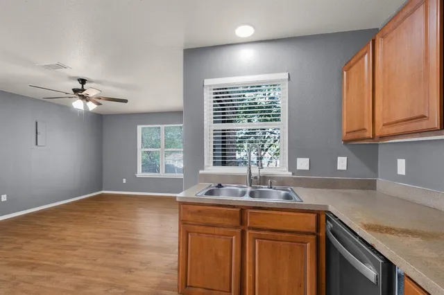 a kitchen with stainless steel appliances granite countertop a sink and a window