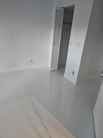 a bathroom with a granite countertop sink and a window