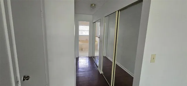 a view of storage and utility room with wooden floor