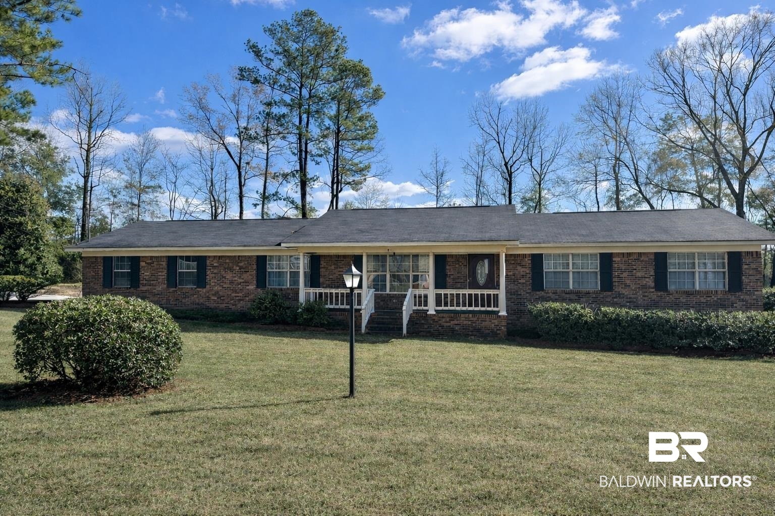 215 Young Street Brewton, AL 36426 - Photo 1 of 25 Single story home with a porch, a front yard, and brick siding