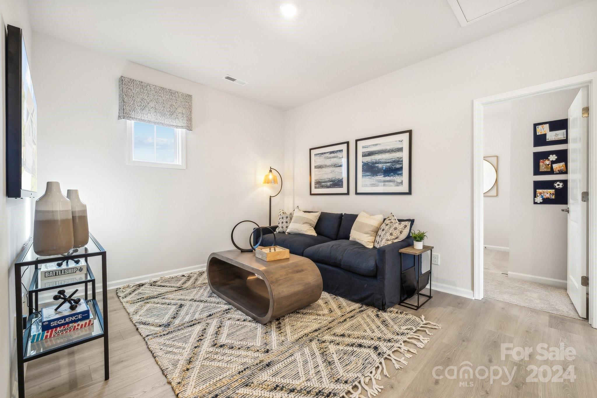 1406 Hubert Graham Way Tega Cay, SC 29708 - Photo 13 of 26 a living room with furniture