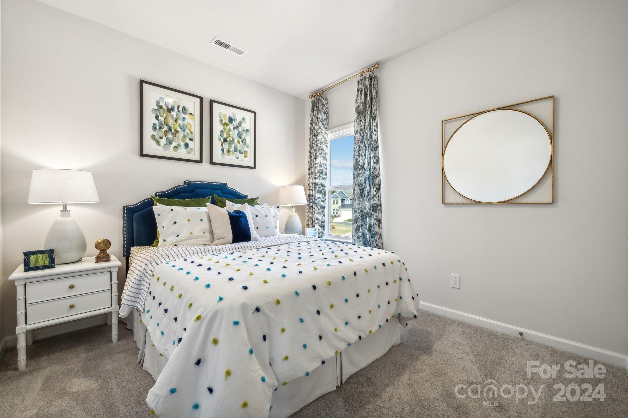 1406 Hubert Graham Way Tega Cay, SC 29708 - Photo 19 of 26 a bedroom with a bed and lamp