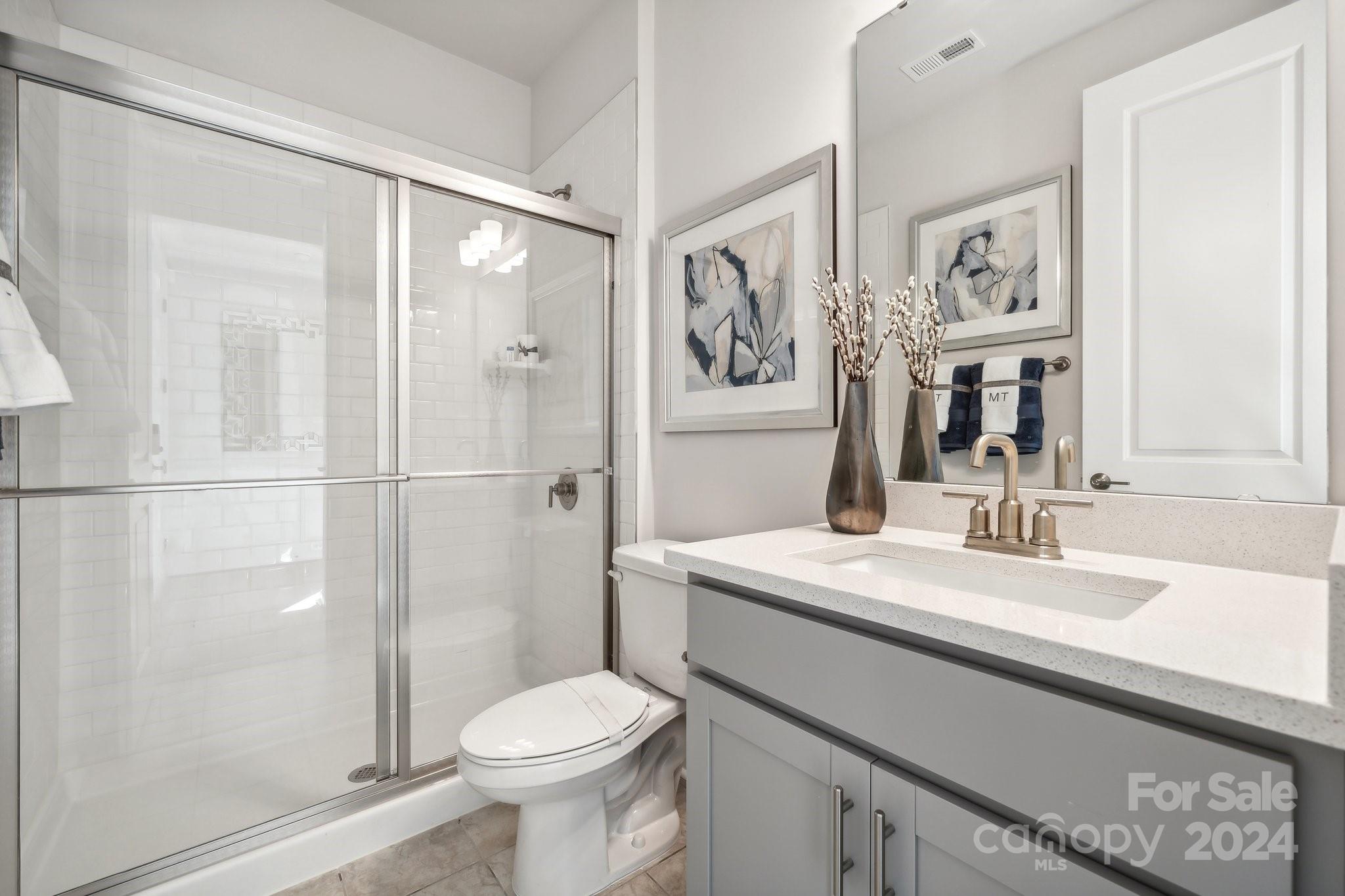 1406 Hubert Graham Way Tega Cay, SC 29708 - Photo 21 of 26 a bathroom with a sink toilet and shower