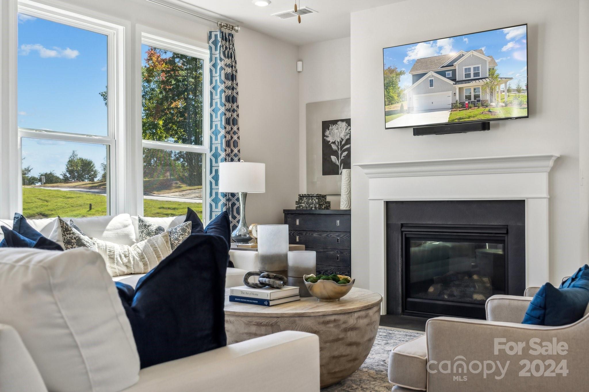 1406 Hubert Graham Way Tega Cay, SC 29708 - Photo 23 of 26 a living room with furniture and a fireplace