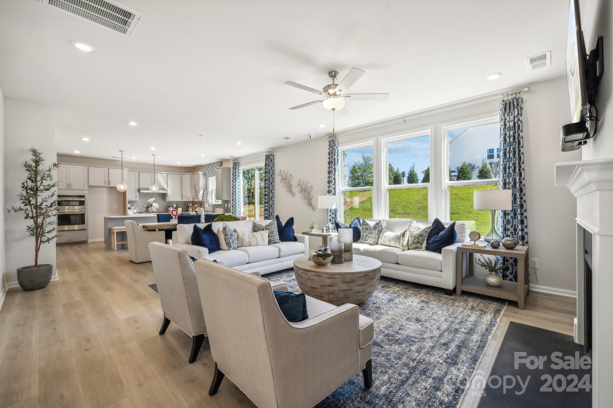 1406 Hubert Graham Way Tega Cay, SC 29708 - Photo 6 of 26 a living room with furniture and a large window