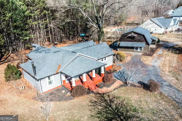 an aerial view of a houses with yard