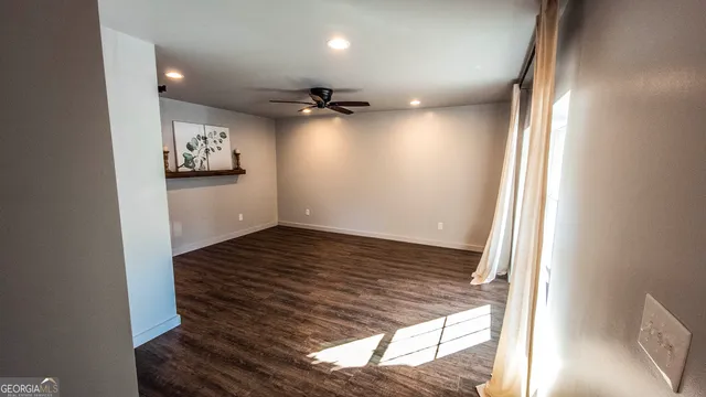 a view of a room with wooden floor and window