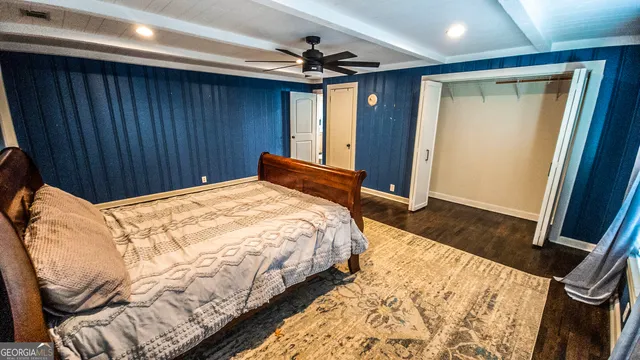 a bedroom with a bed dresser and a window